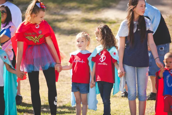 two adults and two kids, all holding hands