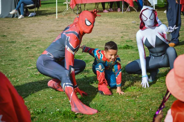 spider man posing for a picture with a child