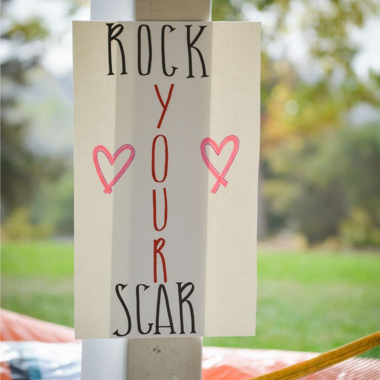 sign that says "rock your scar"