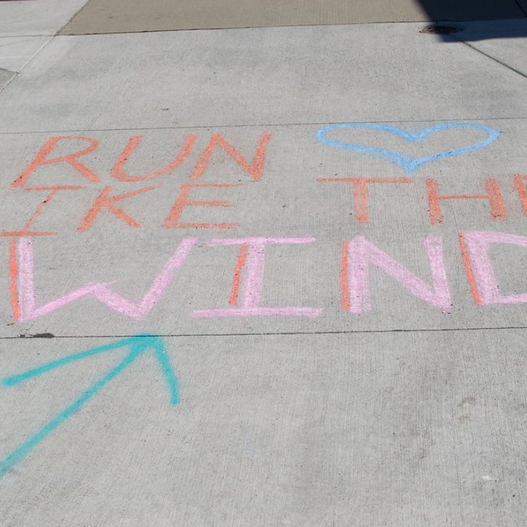 sidewalk chalk that says "run like the wind"